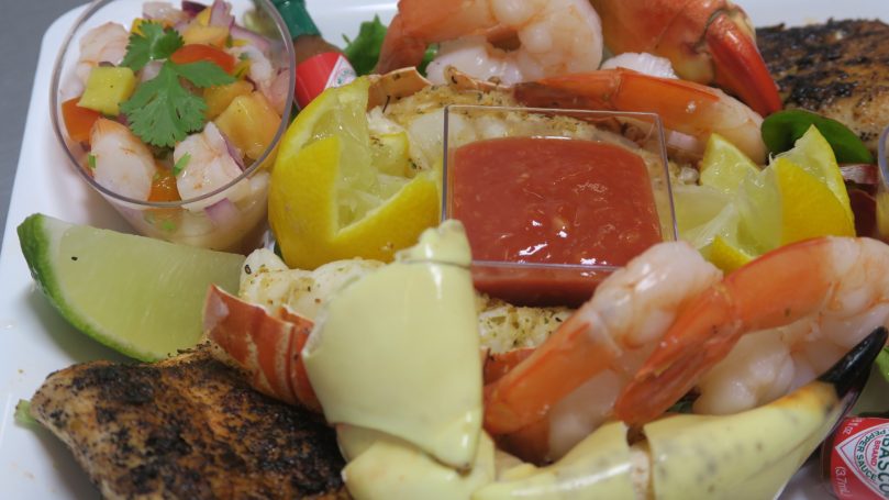 Fresh Key West Seafood Tray. A mixed seafood platter featuring shrimp, fish, lemon, and salsa.