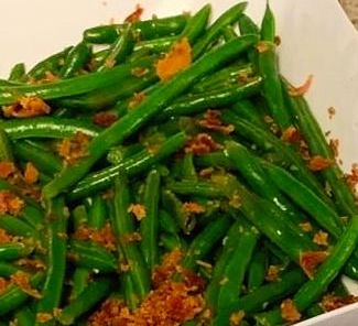 Sweet Chilli Green Beans Cooked green beans topped with crispy bits, served in a white dish.