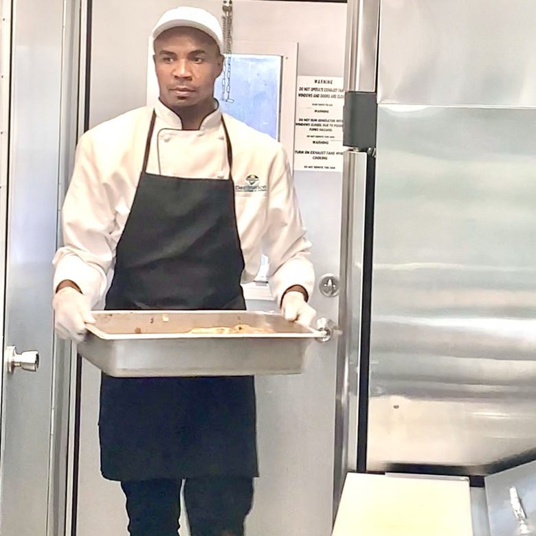 Destination Catering & Events' chef prepping for a Key West wedding in our mobile commercial kitchen.